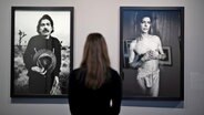   A woman stands for photo & # 39; s by Captain Beefheart (left) and David Bowie on the right) by Dutch photographer Anton Corbijn in the exhibition 