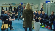 A woman from a football team in a stand, a standing timpani - scene from the "Home Ground" series of Norway © NRK 