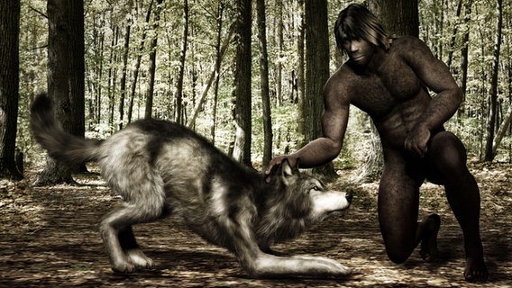 Ein Steinzeitmensch hält einen Wolf am Kopf. © picture alliance | Knut Niehus 