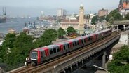 A DT5 subway of Hamburger Hochbahn runs along the harbor.  