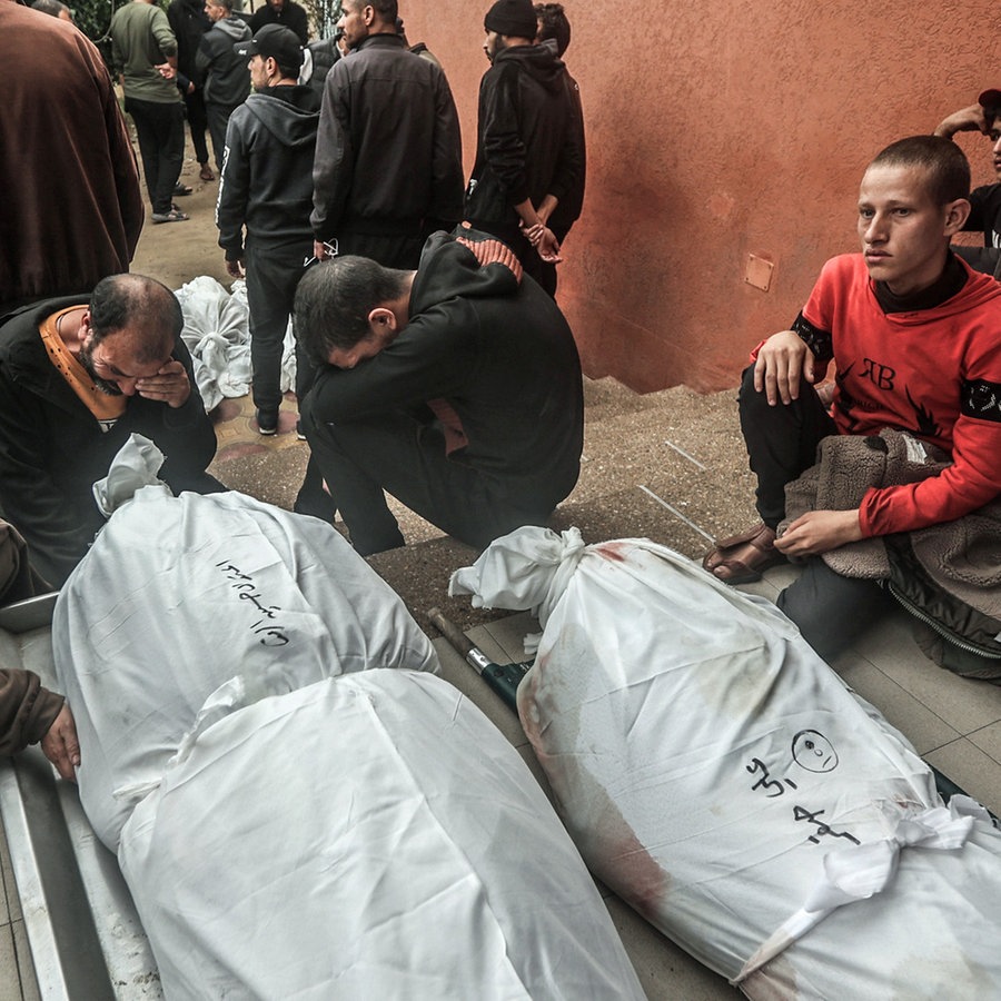 Familienmitglieder von Palästinensern, die bei einem israelischen Bombenangriff getötet wurden, trauern neben ihren verstorbenen Angehörigen. © dpa Foto: Ahmed Zakot