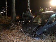 Two cars destroyed next to a road.  