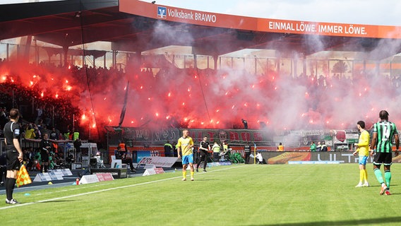 Anhänger von Eintracht Braunschweig zünden Pyrotechnik ab. © IMAGO / regios24 