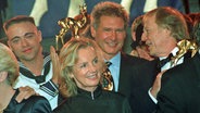 Jil Sander next to Wolfgang Petersen at the 1997 Bambi Awards. © imago stock & people Photo: imago