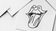 Eine Zeichnung, mit einem Mund, der die Zunge herausstreckt. © Ocke Bandixen Foto: Ocke Bandixen