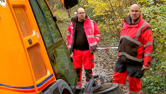 Abschleppunternehmer Jan-Peter Wriedt (rechts) und sein Mitarbeiter Marco Hahlbeck im Botanischen Garten in Kiel. Sie wollen eine Kehrmaschine bergen, die vom Weg abgekommen ist und sich im Schlamm festgefahren hat. © NDR/clipart 