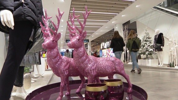 Decorative deer in pink stand in a department store.  