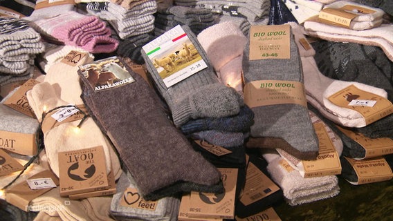 Different socks laid out on a table.  