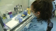 A woman is working on sequencing corona viruses in a laboratory.  