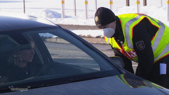 A police officer has to send road users and day vacationers back.  