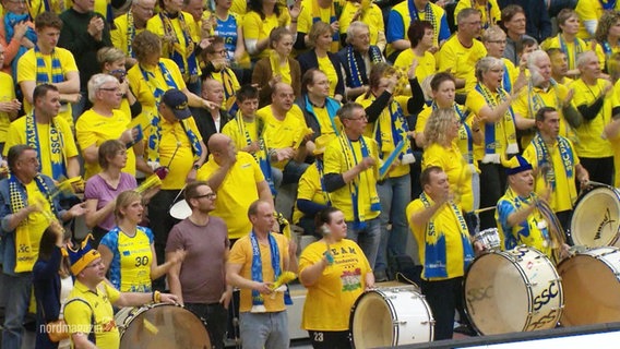 Fans cheer on their team.  