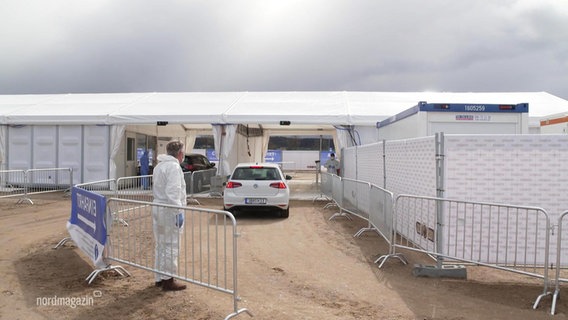 A car drives into a drive-in test center  