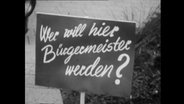 Ein Plakat mit der Aufschrift "Wer will Bürgermeister werden?"  