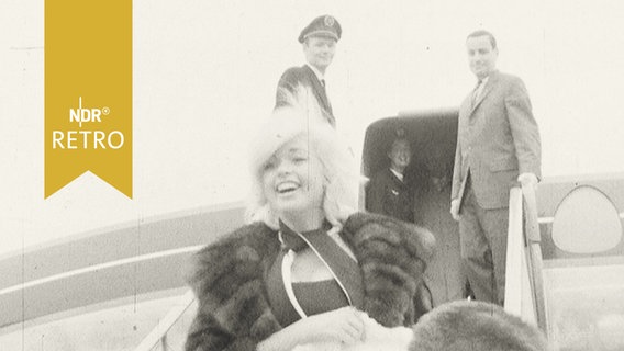 Diva Jane Mansfield kommt lachend die Gangway am Hamburger Flughafen herunter (1963)  