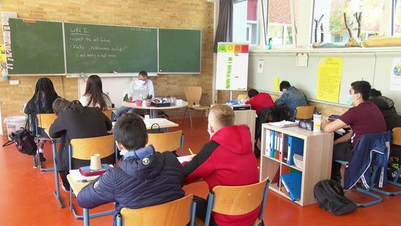 Children sit in school.  