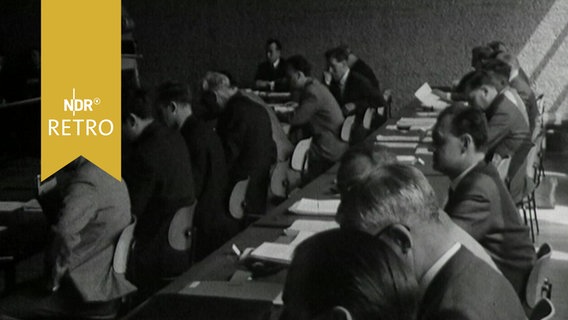 Zahlreiche Männer in einem Seminarraum 1965 bei einem Kolloquium  