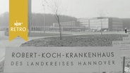 Schlid vor der Silhouette des "Robert-Koch-Krankenhaus des Landkreies Hannover" bei seiner Einweihung 1964  