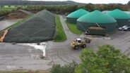 Ein Bagger fährt durch einen Biogas-Betrieb. © Screenshot 