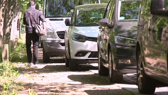 Mehrere Autos parken so auf einem Gehweg, dass kaum mehr Platz für Fußgänger ist. © Screenshot 