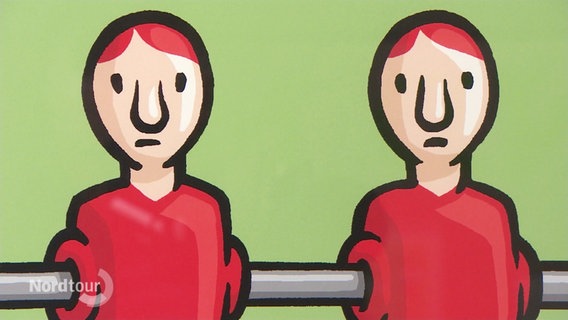 Ein Karikatur zeigt zwei traurig blickende Kickerfiguren. © Screenshot 