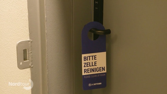 Ein Türschild mit der Aufschrift "Bitte Zelle reinigen". © Screenshot 