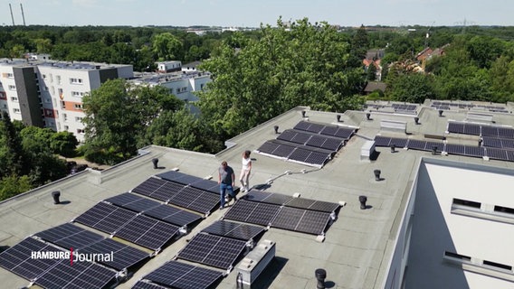 Zwei Menschen laufen über ein Dach, das mit Photovoltaik-Technik ausgestattet ist. © Screenshot 