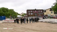 Menschen auf einer Baustelle für einen neuen Busbahnhof in Rahlsted. © Screenshot 