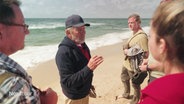 Meer Guide Otto Oldenburg erklärt seinen Gästen am Sylter Strand das Wesen der Gezeiten. © Screenshot 