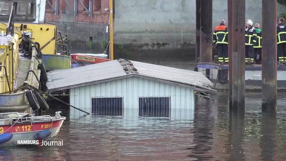 Das Dach eines Arbeitspontons ragt aus dem Wasser der Elbe. © Screenshot 