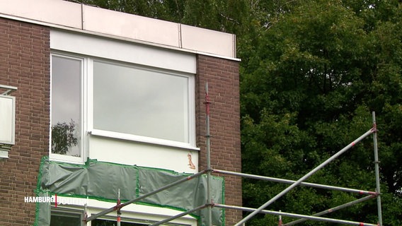 Ein Gerüst steht vor einem Rotklinker-Bau an dem ein Balkon fehlt. © Screenshot 