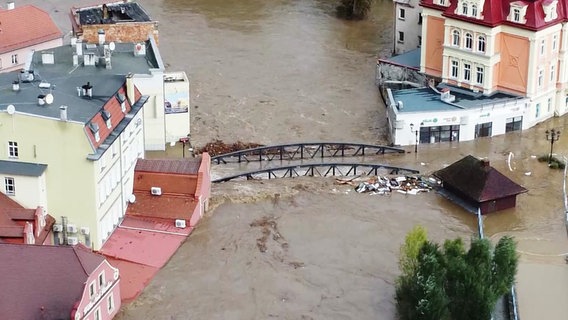 Mehrere Straßen in einem Ort stehen unter Wasser. © Screenshot 