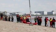 Die DLRG, Feuerwehr und Polizei im Einsatz an einem Strand. © Screenshot 