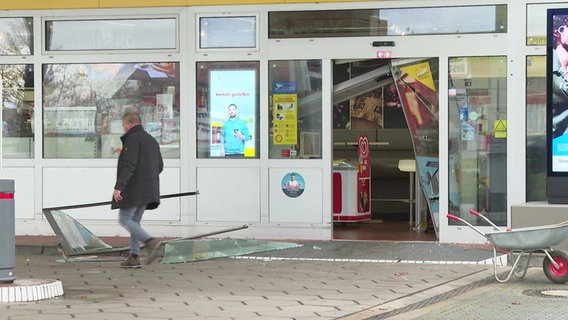 Ein Mann steht vor dem zerstörten Eingang einer Tankstelle in Richtenberg. © Screenshot 