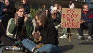 My Body My Choice steht auf einem Plakat bei einer Demo. © Screenshot 