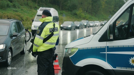 Ein Beamter der Bundespolizei kontrolliert Fahrzeuge an der dänischen Grenze bei der Einreise nach Deutschland. © Screenshot 