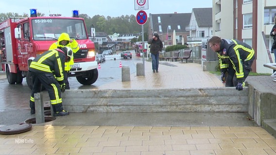 Feuerwehrleute bauen einen mobilen Hochwasserschutz auf. © Screenshot 