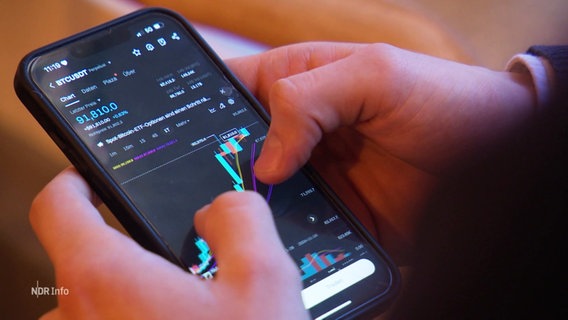 jemand tippt auf einem Smartphone. Auf dem Display sind Bitcoin Daten zu sehen. © Screenshot 