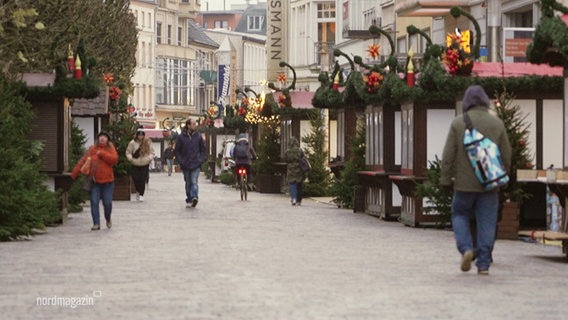 Ein noch nicht eröffneter Weihnachtsmarkt mit Passant:innen. © Screenshot 