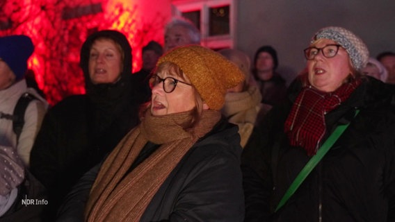 Frauen und Männer singen. © Screenshot 