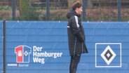 Trainer des HSV Merlin Polzin steht auf einem Fußballrasen. © Screenshot 