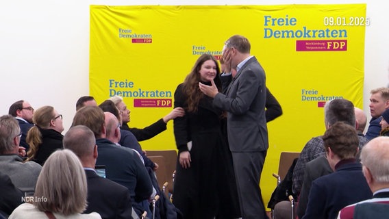 Eine junge Frau drückt FDP-Chef Lindner eine Torte ins Gesicht. © Screenshot 