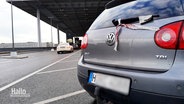 Ein VW Golf mit Hannover-Kennzeichen steht auf einem Parkplatz vor einem Flughafen-Terminal. © Screenshot 