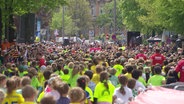 Teilnehmende des Hamburg-Marathons laufen eine Straße entlang. © Screenshot 