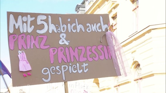 Ein Protest-Schild mit der Aufschrift: "Mit 5 habe ich auch Prinz und Prinzessin gespielt". © Screenshot 