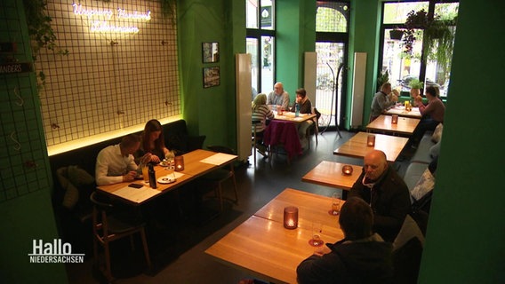 Guests sit in a restaurant.  