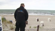 Ordnungsdienst und Polizei am Strand. 