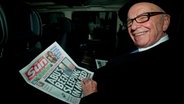 Rupert Murdoch blättert in einer Ausgabe der "Sun" © picture alliance / dpa Foto: Facundo Arrizabalaga