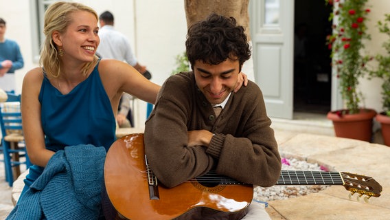 Leonards (Alex Wollf) vertonte Gedichte finden großen Anklang unter seinen Freunden (mit Thea Sofie Loch Næss). © NDR/Nikos Nikolopoulos 