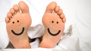 Voetzolen met smileygezicht. © Fotolia Afbeelding: VRD