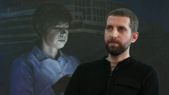 Künstler Ivan Milenkovic vor einem seiner Gemälde © Screenshot 